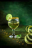 A glass of white wine spritzer with lime