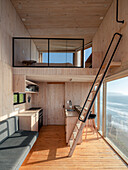 Sleeping loft area above the kitchen in the wooden house