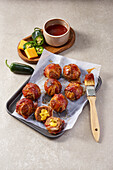 Moink Balls - Grilled meatballs stuffed with cheese and wrapped in bacon