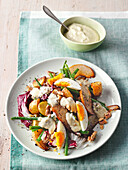 Potato salad with beans, eggs, pea, r and creamy blue cheese dressing
