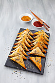 Vegetable filled pastries with sesame seeds cooked in the hot air fryer