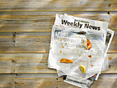 Leftover fish and chips on newspaper