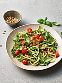 Salad with arugula, zucchini, white beans and pine nuts
