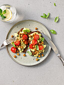 Whole wheat bread with mashed avocado, chickpeas and cherry tomatoes