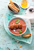 Tomato soup with vegan soy meatballs on skewers