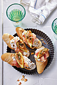Baguette slices topped with fig, ricotta-walnut cream and Serrano ham
