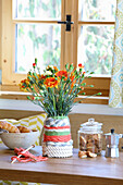 Carnations in woven flower vase