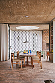 View from the seating area to the kitchen and dining table in front of decorative concrete blocks