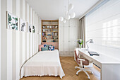 Bed, closet, and desk in a bright Hampton-style girl's room