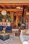 Wood-paneled living room with rustic furnishings and paper lamp