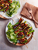 Yakitori with eggplant and spring onions, served with cucumber
