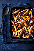 Oven roasted sausage with parsnips and red onions