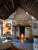 Rustikaler Wohnraum mit Kamin und Torfdach in traditionellem Bauernhaus, Irland