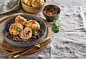 Tyrolean dumplings with red cabbage and fried onions