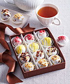 Homemade chocolates with white icing and various toppings