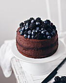 Chocolate cake with chocolate cream, blueberries and blackberries
