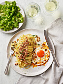 Baby shrimp linguine with dill butter and chili crispy on fried eggs