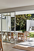 View of covered terrace with table and chairs