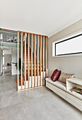 Scandi style entrance hall with staircase and bench seat