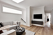 Modern living room in neutral tones at the top of a staircase