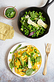 Handmade tagliatelle with asparagus, peas and spring onions