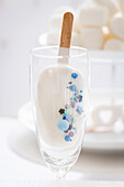 Cake lolly with blue sugar sprinkles
