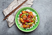 Asian sweet and sour sticky chicken with vegetables stir-fry and rice