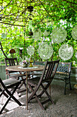 Green seating area with delicate lace hanging decorations