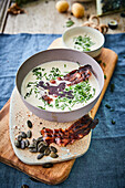 Potato soup with bacon and pumpkin seed oil