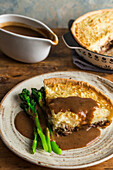 Savory lamb pie with pastry crust and mashed potato topping (England)