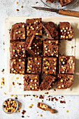 Australian crunchie (chocolate coconut squares) garnished with milk chocolate and mixed sprinkles