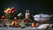 Still life with apples, plums, blackberries, pears and various baking ingredients