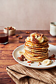 Pancakes with bananas, pecans, and maple syrup