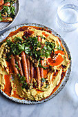 Roasted baby carrot salad with hummus and chili oil