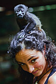 Howler monkey on a woman's head