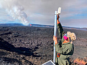 Scientist monitoring eruption, Mauna Loa, Hawaii, USA
