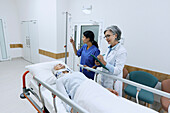 Patient in bed on hospital corridor
