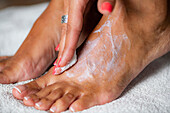 Woman applying foot cream