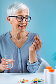 Senior woman taking dietary supplement