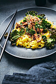 Kale with mushrooms and sprouts on turmeric rice (Asia)