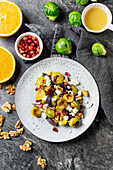 Roasted Brussels sprouts salad with pomegranate, feta, walnuts and orange dressing Christmas