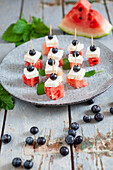 Bites with watermelon, feta, blueberries and mint