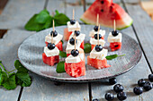 Appetizer plate with watermelon, feta, blueberries, and mint