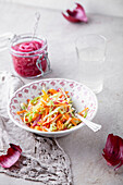 Cabbage salad with spring cabbage, carrots, and pickled red onions