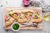 Potato galette with pickled red onions and green spring onions