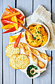 Sweet potato hummus with peppers, crackers, and puff pastry sticks for dipping