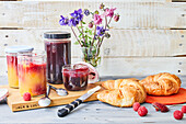 Mango raspberry jam and wild berry jelly, served with croissants