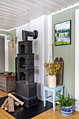 Fireplace with logs, bouquet of flowers and country-style decoration