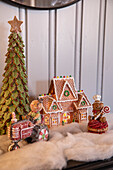 Fireside mantelpiece decorated for Christmas with gingerbread houses and figurines