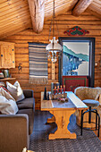 Country-style living room with wood paneling and candles on the table